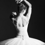 Young beautiful ballet dancer is posing in studio